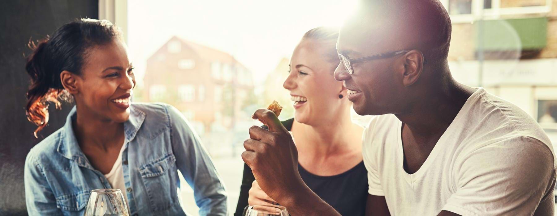 a group of people sitting at a table eating food